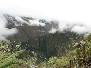 a view of a mountain with a valley in the background